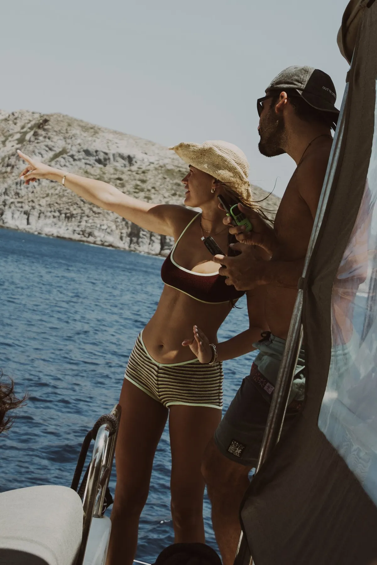 Guest pointing out cliffs from the foredeck