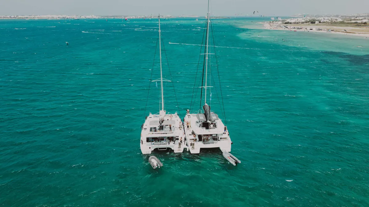Two catamarans anchored in the Cyclades