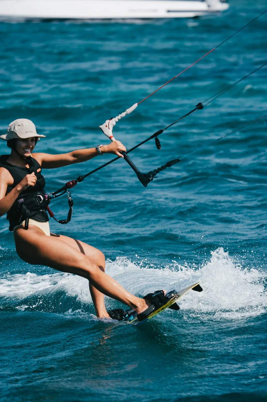 Guest kitesurfing on turquoise water