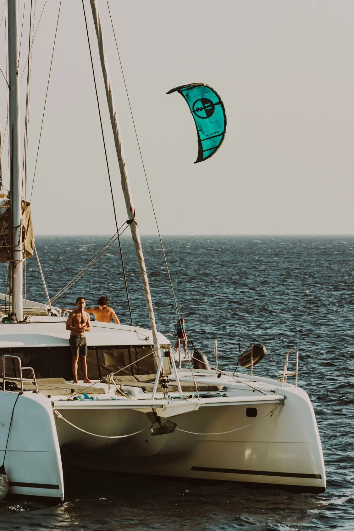 Guests watching a kitesurfer from the deck