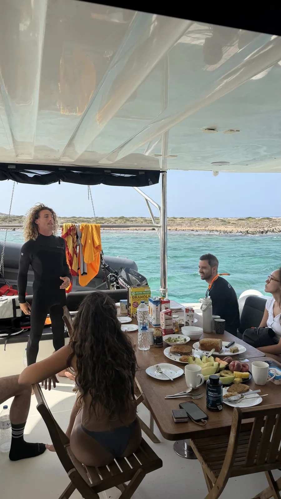 Breakfast around the cockpit table at anchor
