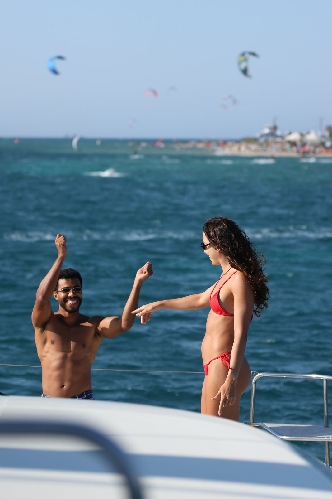 Guests laughing on the bow with kites in the background
