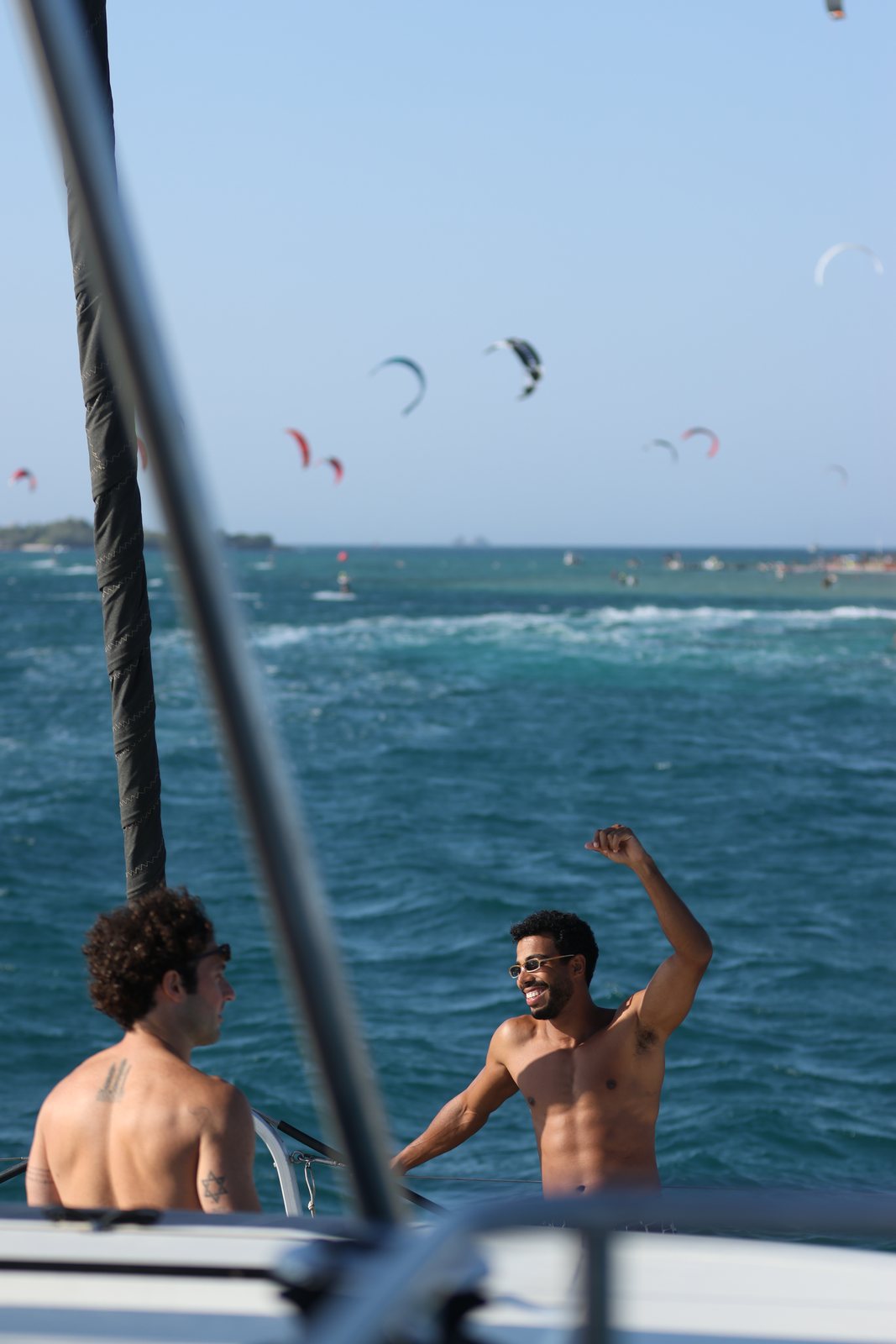 Guest celebrating on deck as kites fly behind