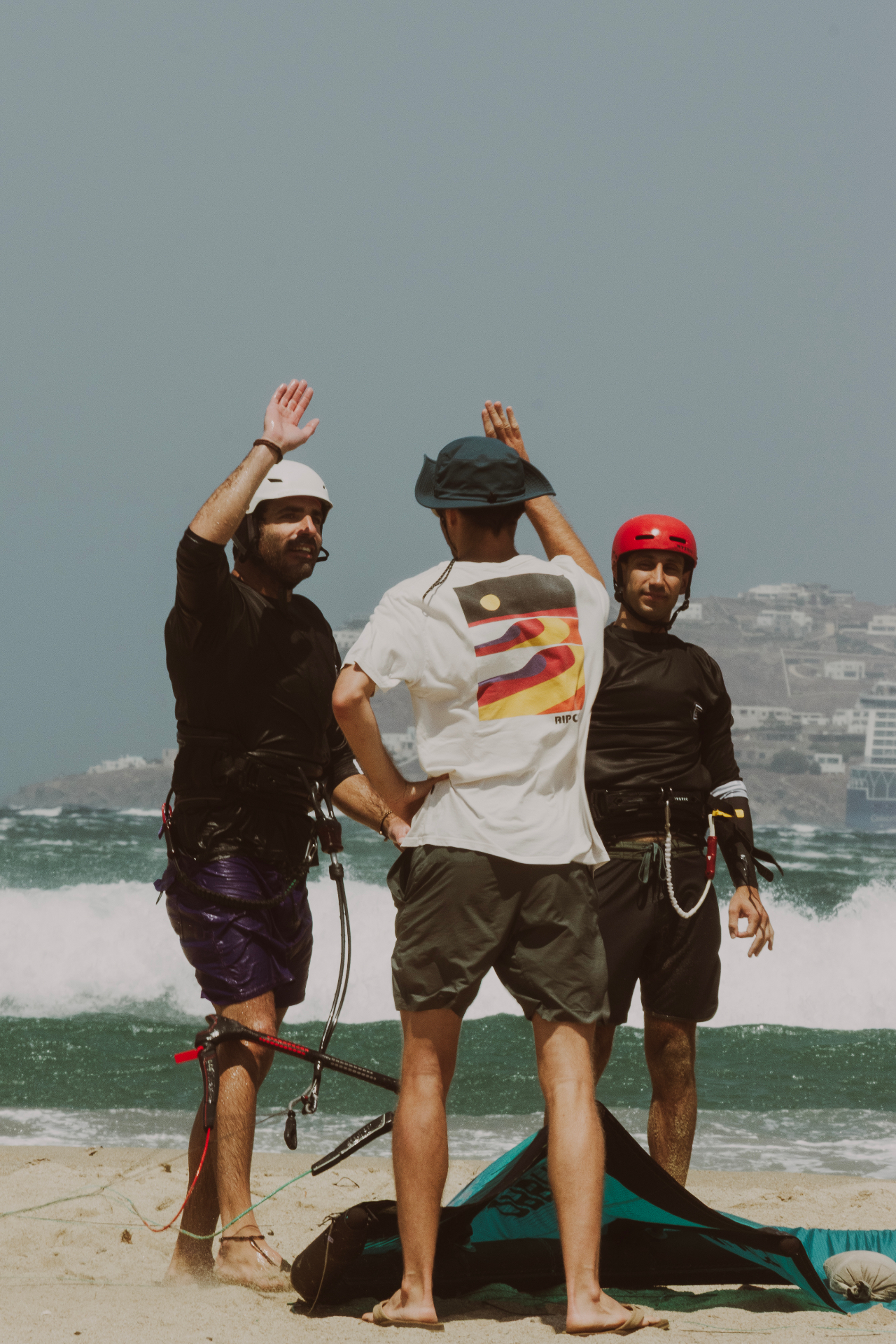 Coach high-fiving riders after a session on the beach